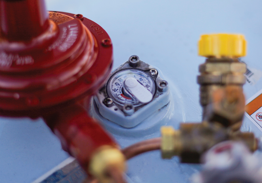 Close-up of the tank gauge on a frost-covered propane tank.